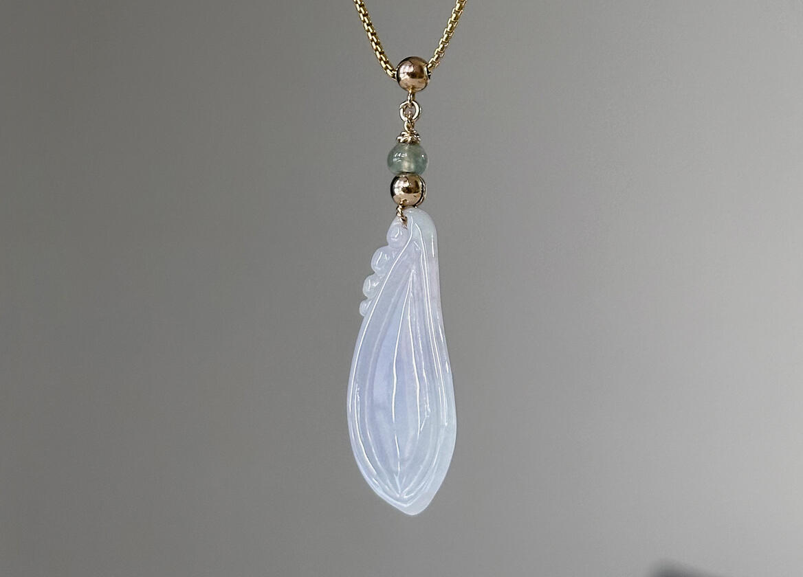 Back of Lavender Tinted Teardrop Shaped Jadeite Pendant hanging natural light